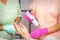 Beautician disinfects hands with antiseptic spray