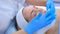 Beautician doctor wiping woman face using antibacterial napkins, hands closeup.