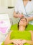 Beautician doing diamond microdermabrasion on woman