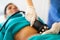 Beautician doing ultrasound cavitation procedure in woman& x27;s abdominal region