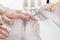 Beautician with gloves professional painting finger nails on young girl in manicure beauty studio