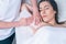 Beautician hands doing depilation in woman armpit