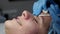 The beautician makes a cleansing of the nose area during the procedure of mechanical facial cleansing