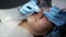 The beautician makes a cleansing of the nose area during the procedure of mechanical facial cleansing