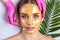 Beautician makes a gold face mask of a woman to rejuvenate the skin. Cosmetology treatment of problem skin on the face and body