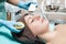 Beautician makes Ultrasonic cleaning of face. cosmetology