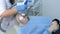 Beautician making laser carbon face peeling procedure to woman, hands closeup.