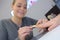 Beautician performing procedure on client\'s nails