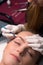 Beautician plucking eyebrows. Eyebrow care in a beauty salon