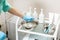 Beautician preparing for procedure. nurse wets sponge in water in bowl. tools in medical basin on table.