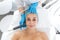 Beautician procedure ultrasound fonoforeza patient face. A young girl is undergoing a course of spa treatments in the office of a