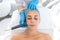 Beautician procedure ultrasound fonoforeza patient face. A young girl is undergoing a course of spa treatments in the office of a