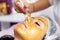 Beautician with special brush puts on face girl golden mask