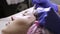 Beautician squeezing pimple blackheads for young wonan in beauty salon. facial skin care