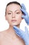 Beautician touch and exam health woman face