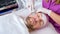Beautician using electrical impulses for facial procedures.  Man in a spa salon on cosmetic procedures for facial care. Adult man