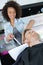 Beautician washing male clients hair in salon
