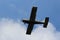 Beautifful blue sky with the clouds and flyinf the Single-propeller sports aircraft