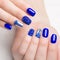 Beautifil blue manicure with rhinestone. Nail Design. Close-up