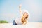 Beautifil young woman lying on the beach at sunny