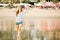 Beautifil young woman walking along the beach at