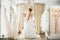 Beautifu bride choosing wedding dress in a wedding salon