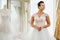 Beautifu bride choosing wedding dress in a wedding salon