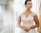 Beautifu bride choosing wedding dress in a wedding salon