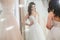 Beautifu bride choosing wedding dress in a wedding salon