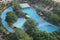 Beautifuil swimming pool with blue water and green tree around the pool