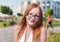 Beautiful 20s aged redhead smiling woman outdoors