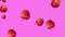 Beautiful Abstract colorful animation of Red Apples falling and rotating against pink background.