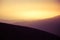 A beautiful, abstract, colorful sunset scenery in mountains in warm tones. Mountain landscape in colors.