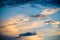 The beautiful abstract complex mixed image of the clouds over the lake of the City Park at the spring sunset