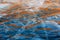 Beautiful abstract frozen blue orange ripples of water of Lake Baikal