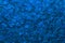 Beautiful abstract shimmer classic blue sequin background texture close up. Party concept