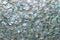 Beautiful abstract shimmer silver turquoise sequin background texture close up. Party concept.