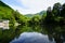 Beautiful abundant natural green mountain landscape symmetrical reflection on fresh lake Kinrin with blue sky background