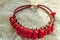Beautiful accessory - a red beaded necklace, necklace, fashion jewelry lies on Lacy napkin