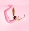 Beautiful acrobatic woman in pink latex costume