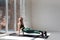 Beautiful active woman in sport clothing stretching body on yoga mat