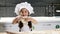 Beautiful adorable girl in chef hat play with dough and flour in house kitchen. Children chef concept. Kids play adults