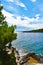 Beautiful Adriatic sea in Croatia. Green pine  rocks  turquois water  vertical photo