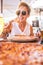 Beautiful adult middle age beautiful woman enjoying tasty italian natural pizza at the restaurant pizzeria - people eat