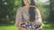 Beautiful adult woman holding a basket with plums