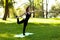 Beautiful adult woman in park engaged in yoga and gymnastics outdoors. Healthy lifestyle, caring for body