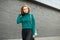 Beautiful adult woman smiling. Green knitted sweater. The concept of fashion, lifestyle, urban