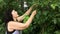 Beautiful adult woman tears and eats mulberry fruits.