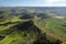 Beautiful Aerial countryside landscape with green meadow and wind turbine farm in the background.