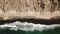 Beautiful aerial establishing birdseye view of baltic sea coast on a rock and red sand